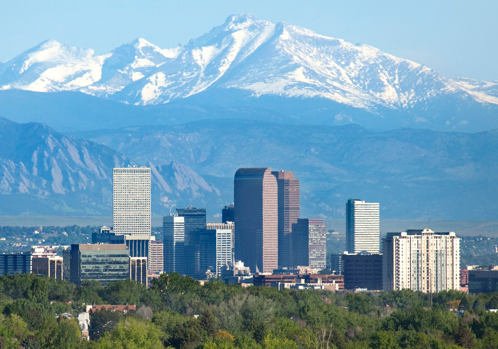 photo of downtown Denver and snow-capped mountains